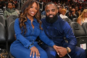 Kandi Burruss and Todd Tucker wearing blue jumpsuits and sitting courtside at an Atlanta Hawks game