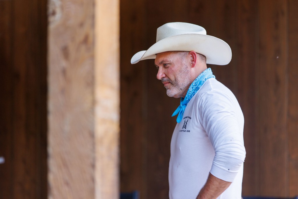Steve McBee Sr in a white shirt, cowboy hat, and blue bandana