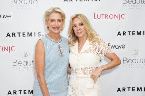 Dorinda Medley in a blue dress posing with Ramona Singer, who is wearing a white dress and has her hand on her hip