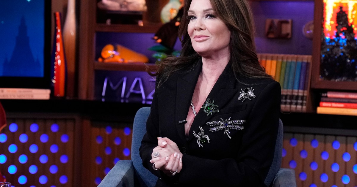 Lisa Vanderpump in a black suit with her hands folded on Watch What Happens Live