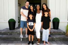 Wendy Osefo in a white dress, posing with her new family on Wife Swap
