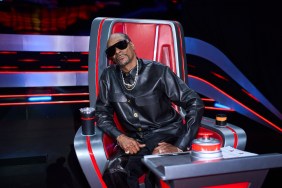 Snoop Dogg dressed in all black, sitting in his red chair on The Voice
