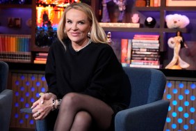 Heather Gay in a black sweater, sitting with her legs crossed on Watch What Happens Live