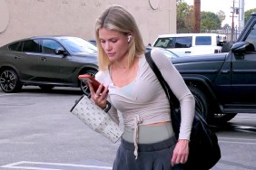 Witney Carson walking in a parking lot while staring at her phone