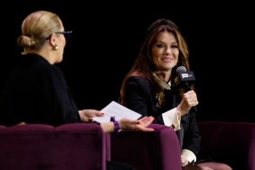Lisa Vanderpump on stage at BravoCon, smiling and holding a microphone