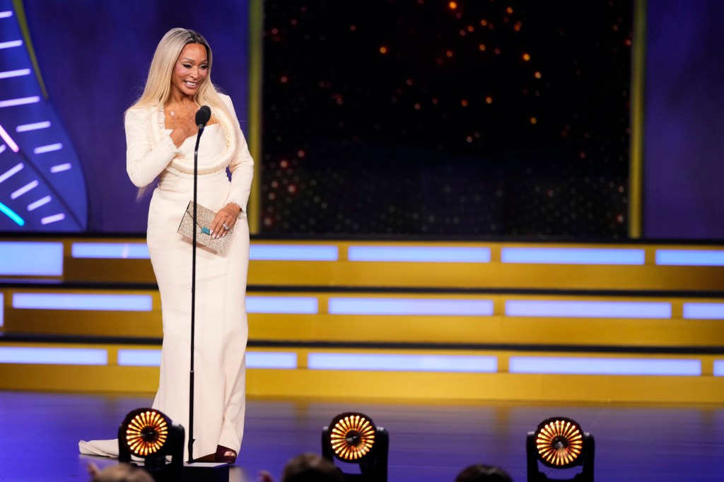 Karen Huger in a white gown on stage at BravoCon 2025