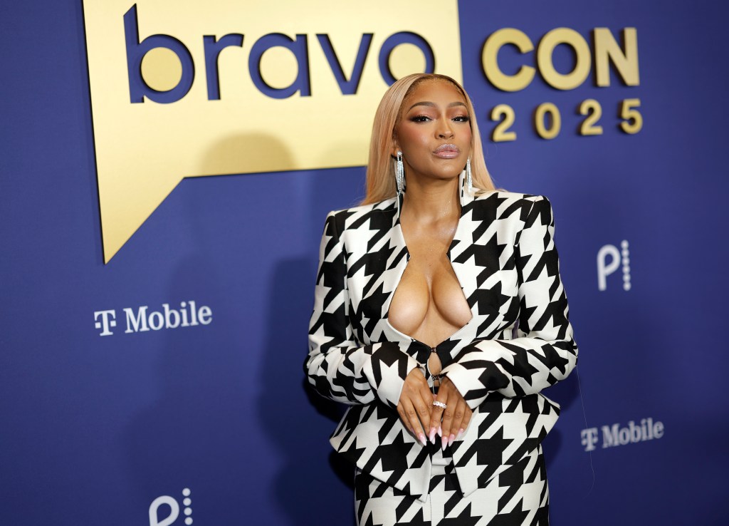 Drew Sidora in a houndstooth suit at BravoCon 2025