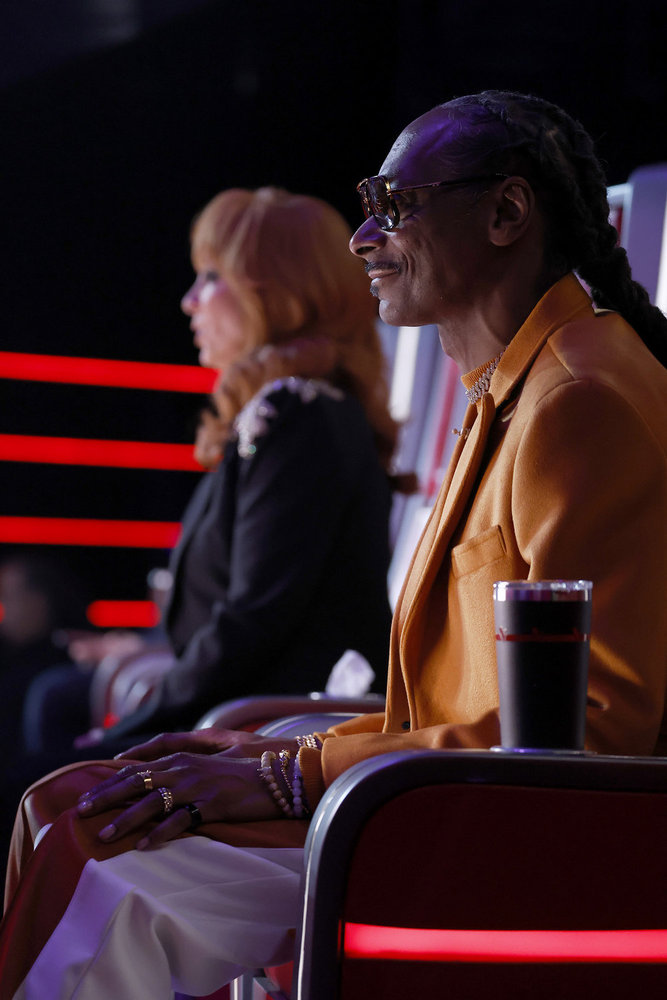 Snoop Dogg and Reba sitting in their red chairs on The Voice