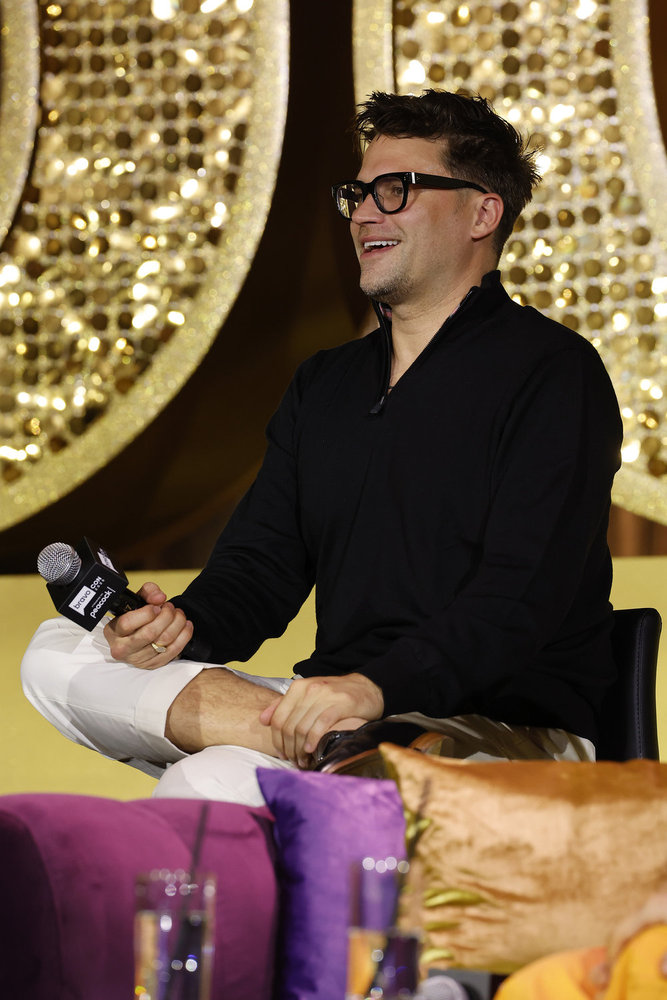 Tom Schwartz in a black suit on stage at BravoCon 2025