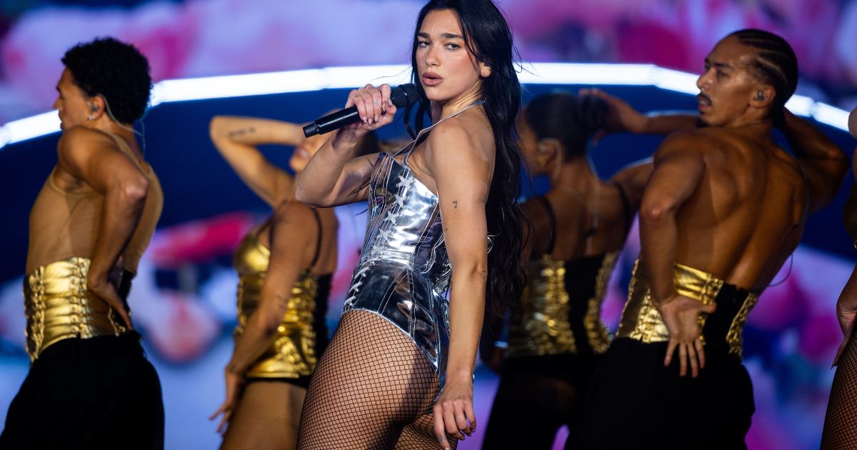 Dua Lipa’s Cheeky Bodysuit Photo Comes With Fishnet Stockings
