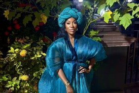 Wendy Osefo in a blue Nigerian outfit posing with her hand on her hip