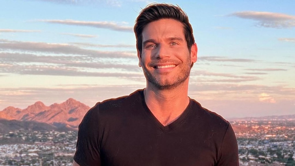 Chad Spodick posing in a black shirt with Phoenix, Arizona in the background