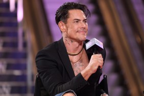 Tom Sandoval in a black blazer holding a microphone at BravoCon 2023