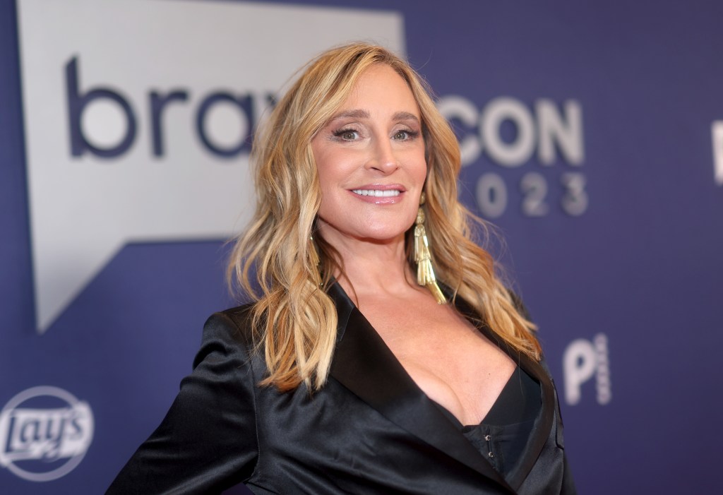 Sonja Morgan in a black blazer posing on the BraovCon red carpet