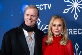Rick Hilton in a black scar posing with Kathy Hilton in a red dress at a DIRECTV Christmas event