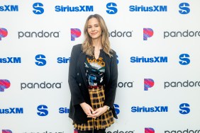 Meghan King in a plaid skirt and black blazer, posing at SiriusXM studios