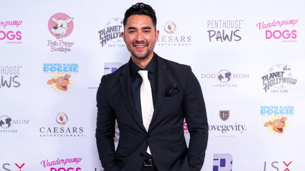 Marciano Brunette in a black suit and white tie at a Vanderpump Dogs event