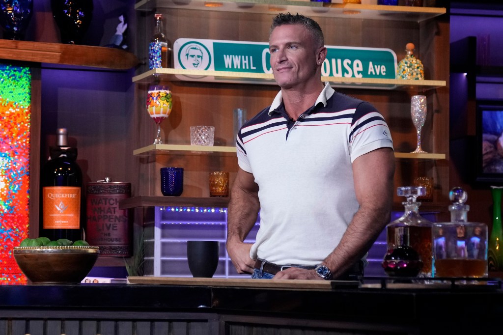 John Hill in a white polo shirt behind the bar at Watch What Happens Live