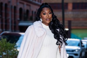 Wendy Osefo in a white coat walking through traffic