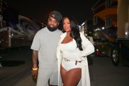Kandi Burruss in a white bodysuit posing with Todd Tucker in a grey shirt