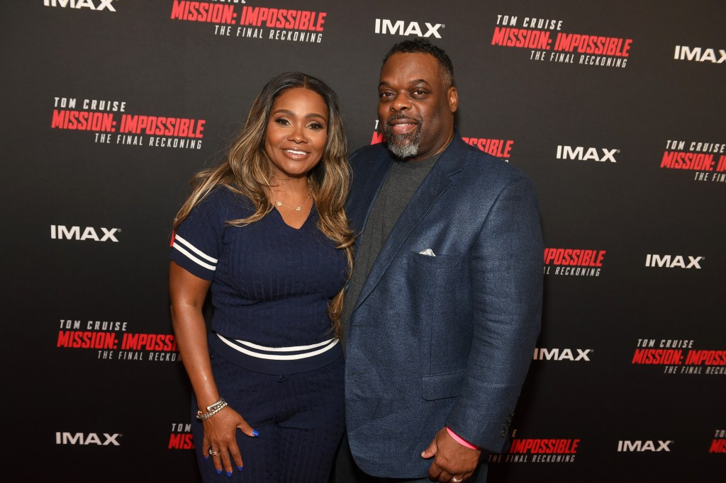 Dr. Damon Kimes and Dr. Heavenly Kimes at a red carpet event, both dressed in navy blue