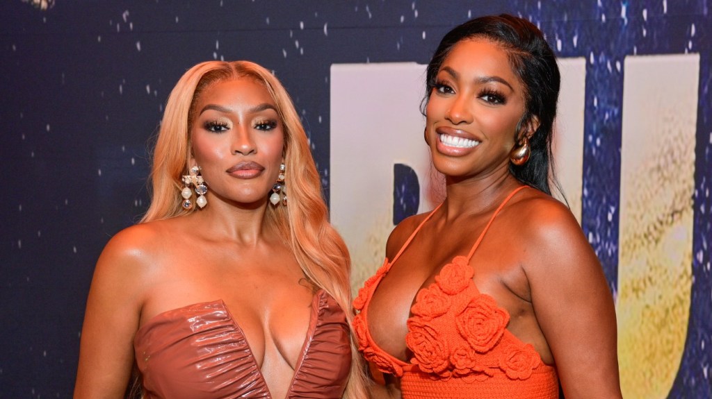 Drew Sidora and Porsha Williams posing together at the premiere of Run