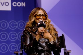 Mary Cosby in a black leather jacket on stage at BravoCon 2025, holding a microphone and smiling