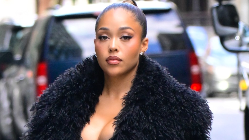 Jordyn Woods' Sheer Bra Steals the Spotlight in Fur Look
