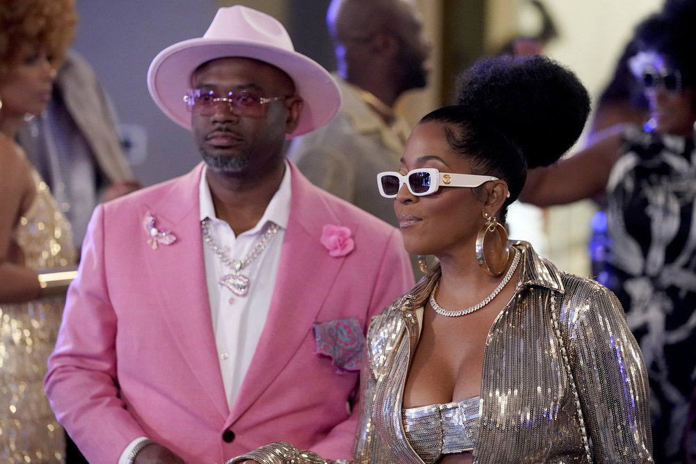 Toya Bush Harris and Eugene Harris attending a 70s themed party 