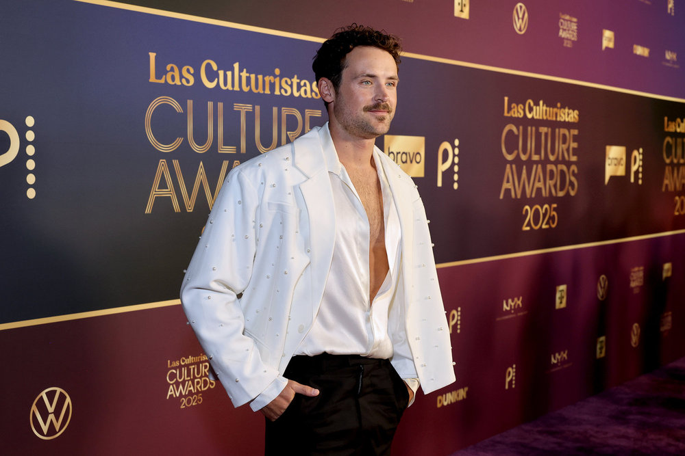 Dylan Efron in a white shirt on the red carpet at the Las Culturistas Awards