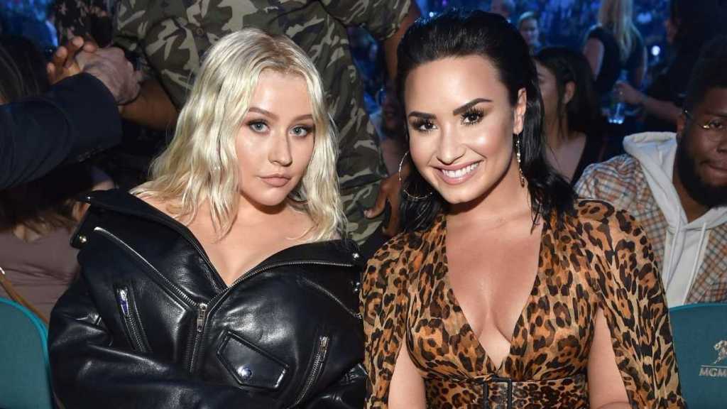 Demi Lovato & Christina Aguilera's Tiny Minidresses Are Hidden Under Fur Coats