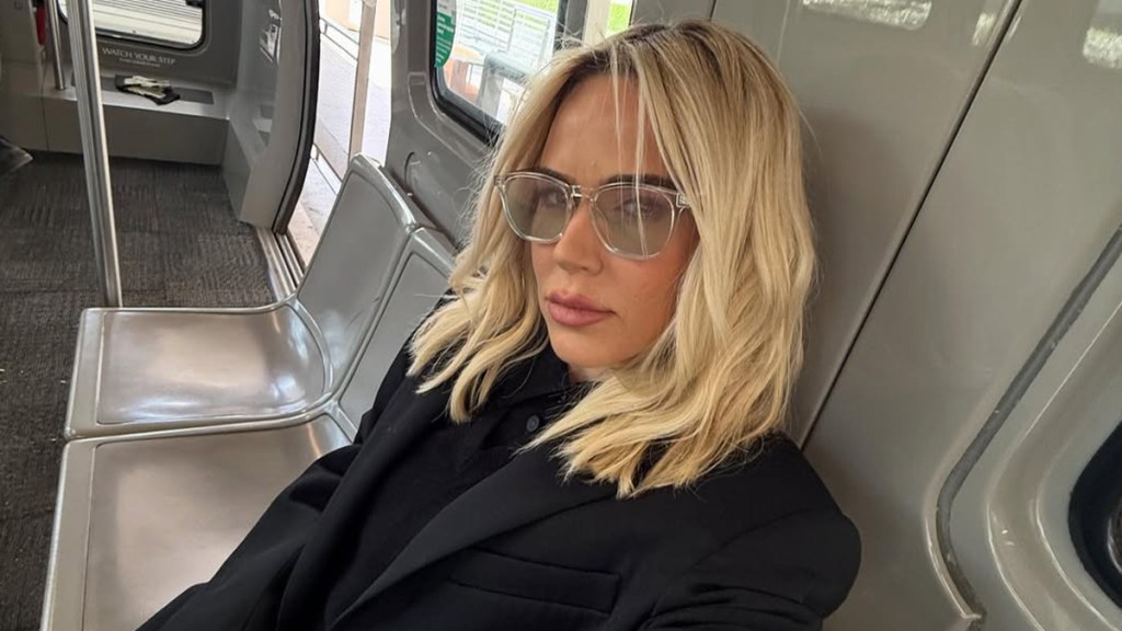 CJ Perry Wears Tiny PJ Shorts & Sips Coffee in Bed in Video