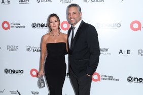 Kyle Richards and Mauricio Umansky dressed in black posing together on a red carpet