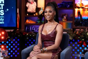 Monique Samuels in a red dress smiling on Watch What Happens Live