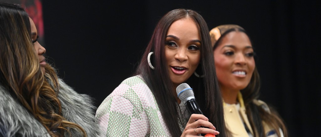 Dr. Heavenly. Kimes, Dr. Mimi Sanders and Toya Bush-Harris speaking on stage at at event