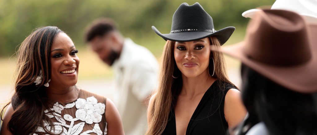 Ashley Darby in a cowgirl hat, standing with Tia Glover on Real Housewives of Potomac