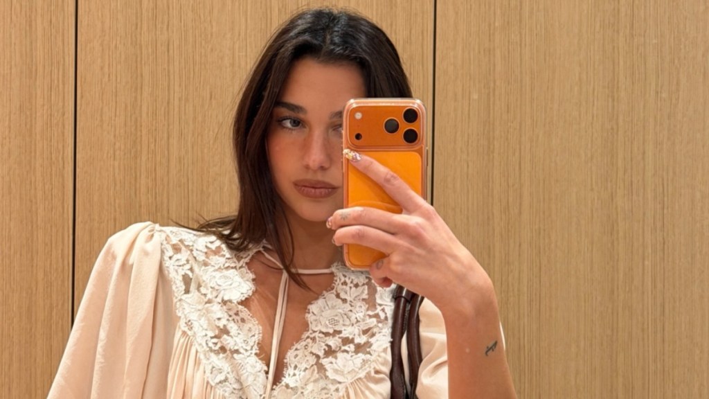 Dua Lipa’s Lace Bra Peeks Out From Low-Cut Top