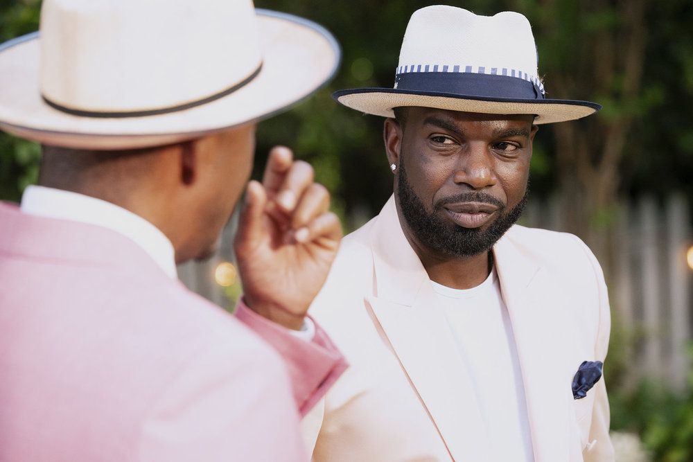 King from Married to Medicine in a white hat and jacket 