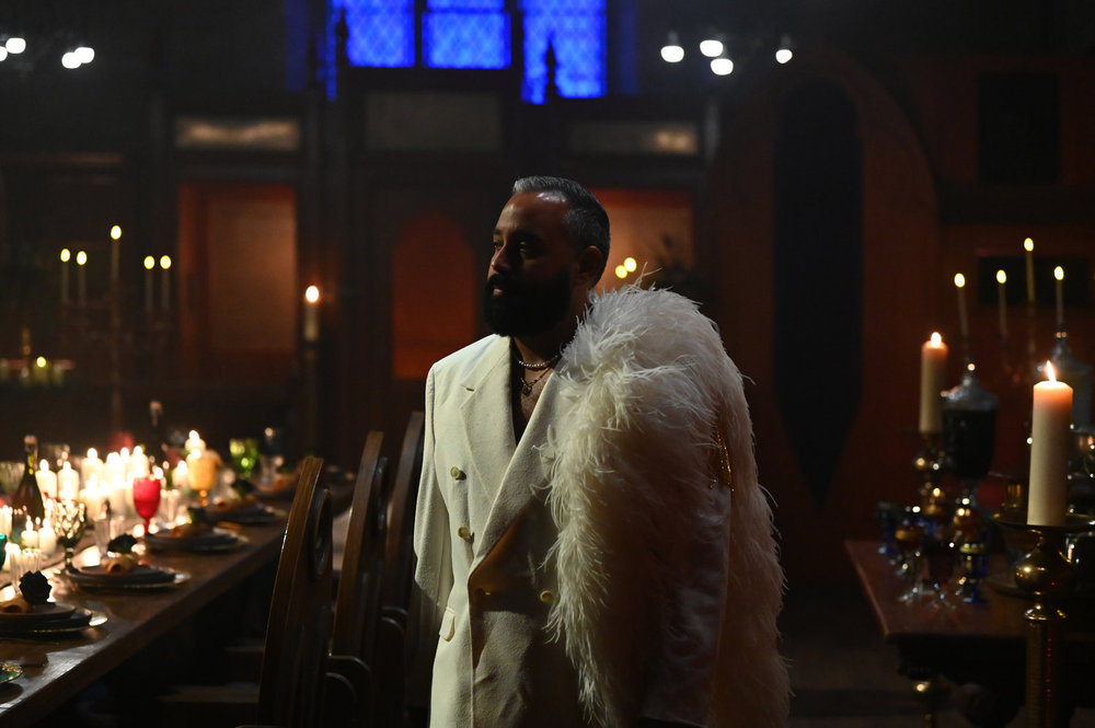 Yam Yam Arocho in a white fur suit at the Black Banquet on Season 4 of The Traitors