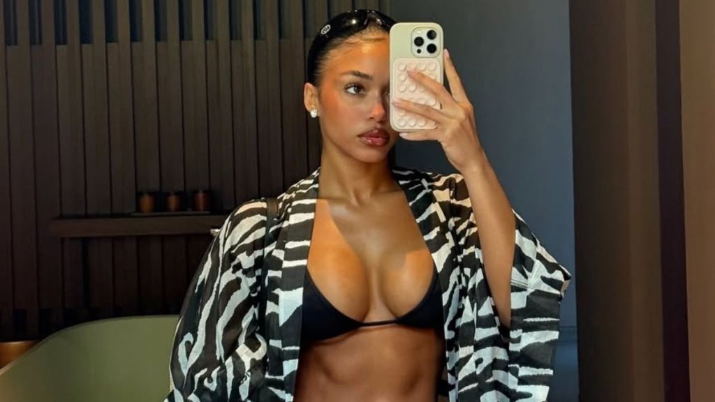 Lori Harvey’s Chanel Bikini Thong & Baby Tee Is a Beach Siren Look