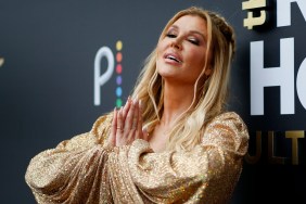 Brandi Glanville in a gold dress, folding her hands