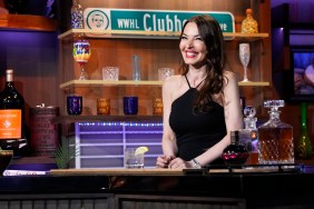 Drita D'Avanzo in a black dress behind the bar on Watch What Happens Live