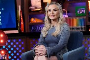 Tamra Judge in a denim dress, sitting with her legs crossed on Watch What Happens Live