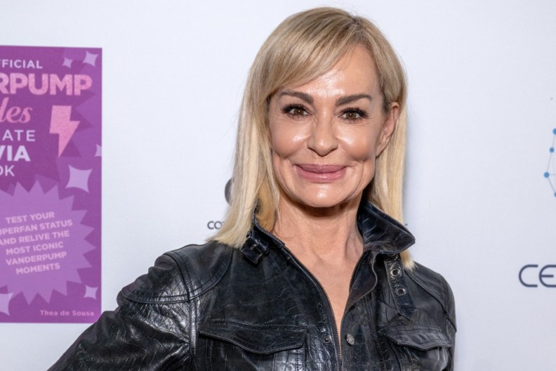 Taylor Armstrong smiling and wearing a black leather jacket