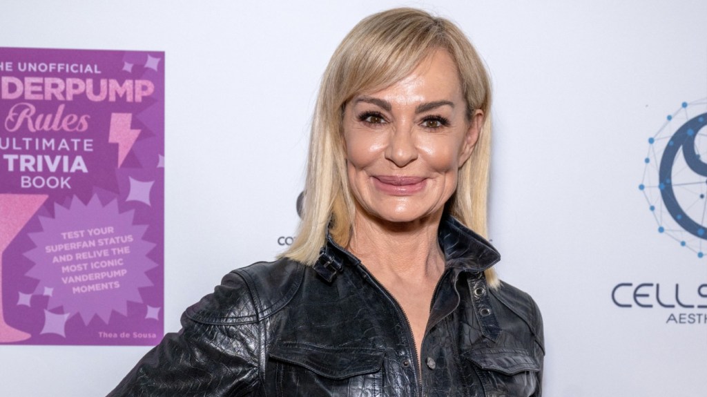 Taylor Armstrong smiling and wearing a black leather jacket