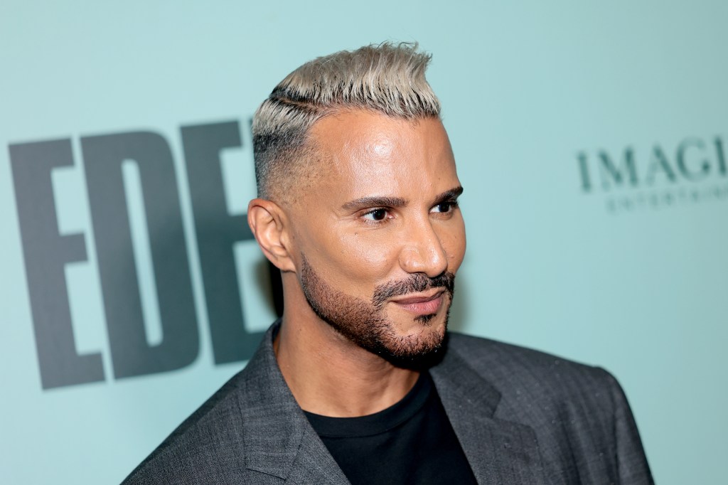 Jay Manuel in a grey blazer at a red carpet event
