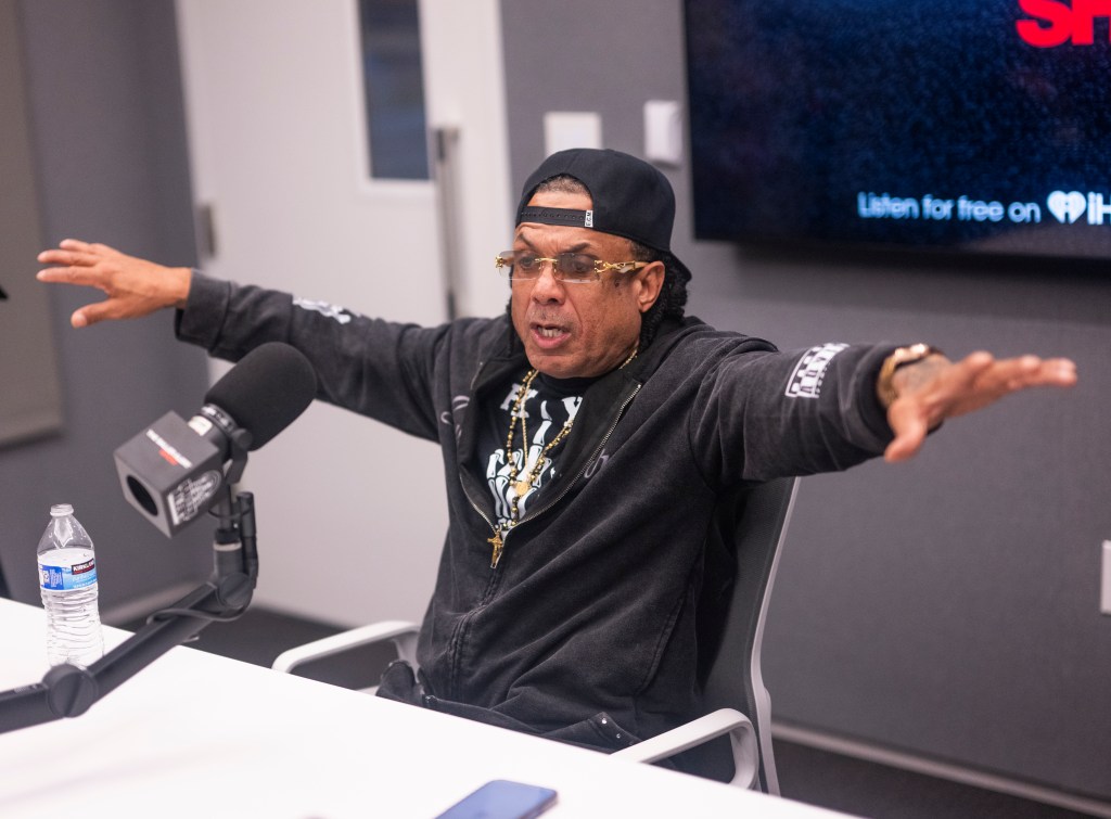 Benzino doing an interview at a radio station and holding his arms out