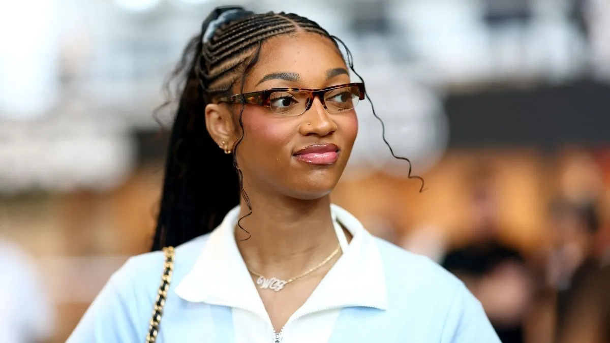 Angel Reese in strappy string bikini posing on yacht vacation