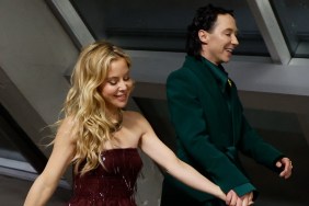Johnny Weir in a green walking hand in hand with Tara Lipinski, in a sparkly red dress