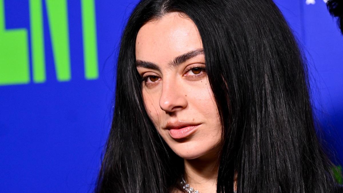 Charli XCX in black bikini bottom and jacket at The Moment UK premiere 2026